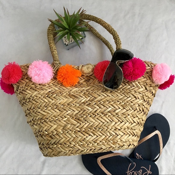 straw tote with pom poms